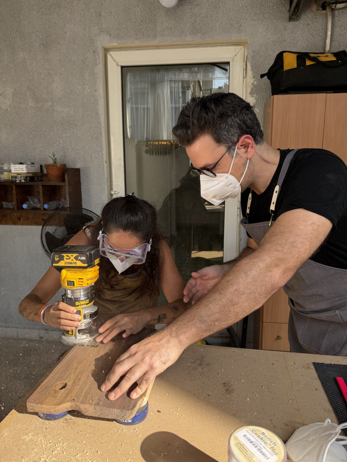 Guiding a guest as she rounds the edges with the router